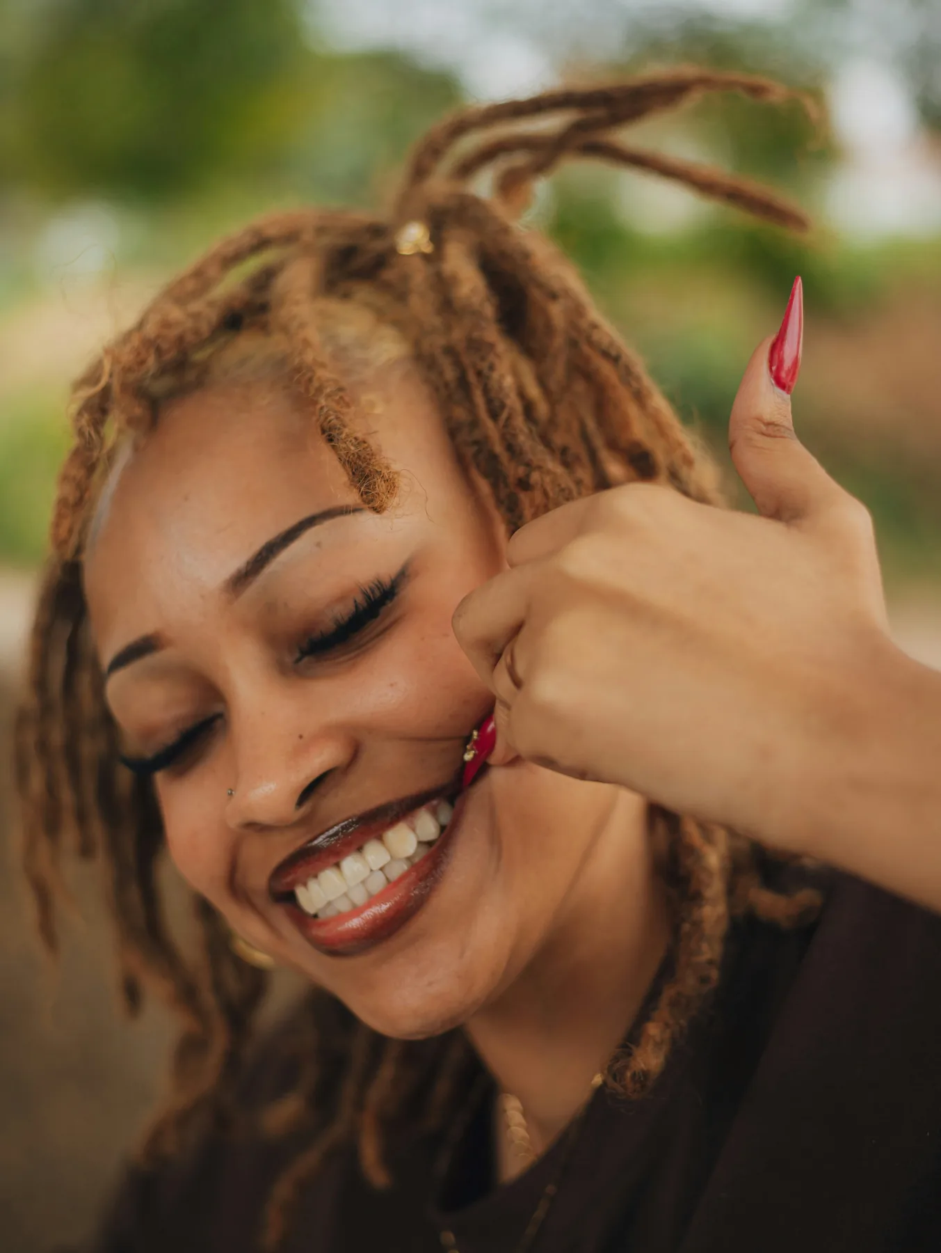 Adult woman smiling during a relaxed phone conversation