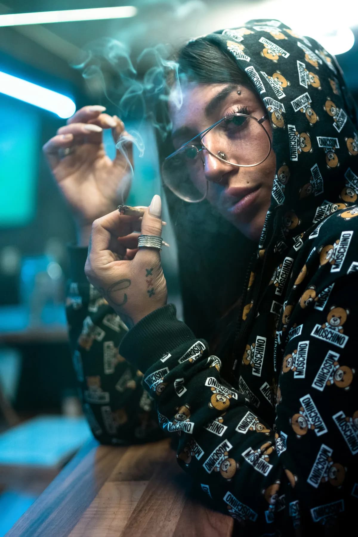 Adult holding a cannabis product in a relaxed social setting
