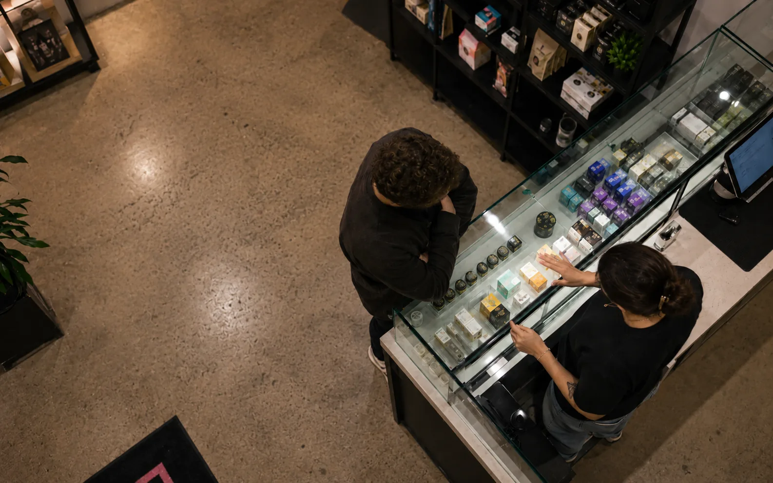 A Dazed team member guiding an adult customer at the product counter